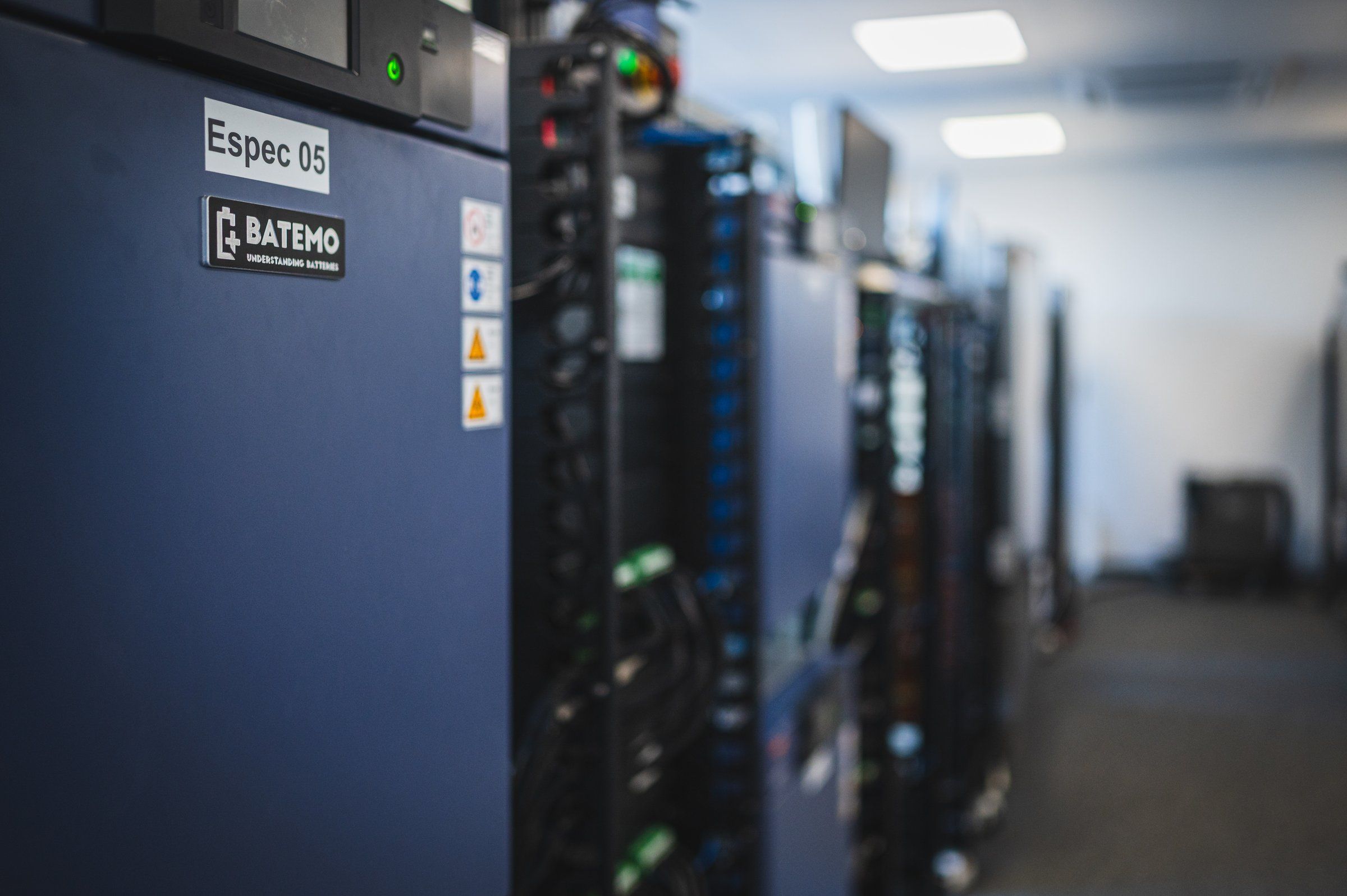 Climate chamber labeled Espec 05 with a Batemo asset plate, test racks receding behind it